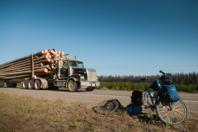 A timber truck thunders past as I fix a puncture - my first in 4500kms. 