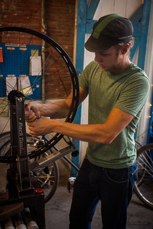 The wheelsmith at work. Kindly, Charlie at 2WD offered us the use of their truing stand, once we'd laced the wheel up.